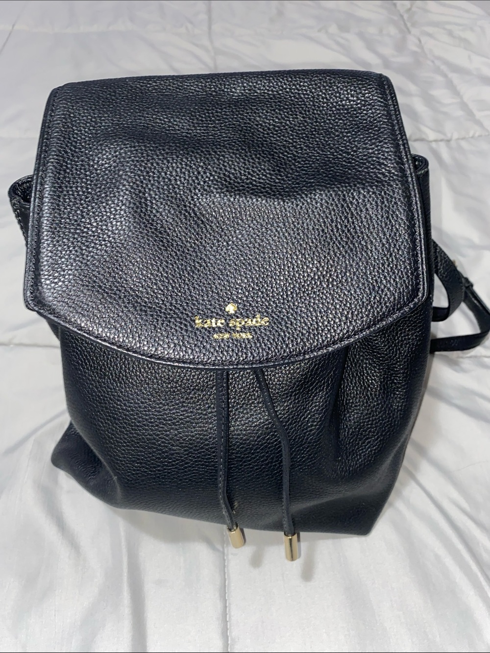kate spade Black Pebbled Leather Drawstring Backpack with Gold Accents